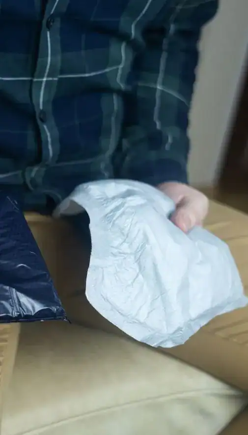 Image of man holding incontinence pads as part of overactive bladder treatment Blackpool