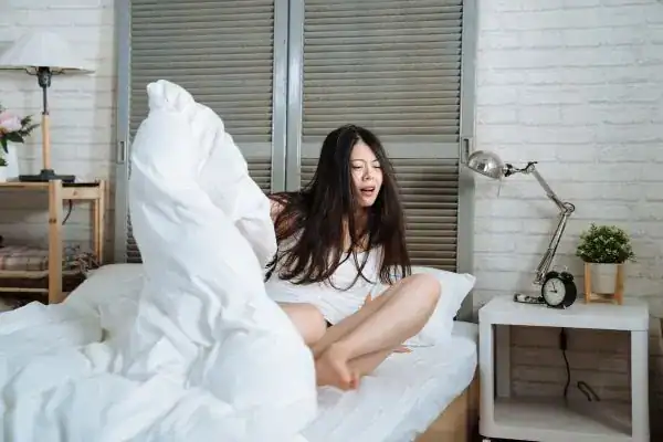 Image of woman getting up because of nighttime leaks Blackpool